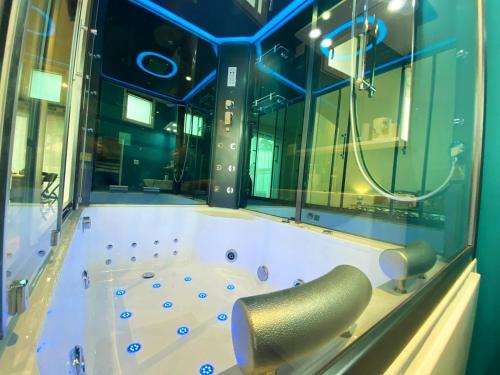 a bathroom with a jacuzzi tub with blue lighting at BalnéoPlage in Jard-sur-Mer