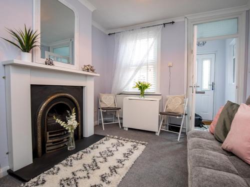 a living room with a fireplace and a couch at Central cosy home 5 minutes walk from Shrewsbury - Pass the Keys in Shrewsbury