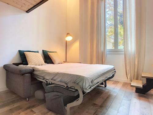 a bed in a room with a large window at Cannes centre - Superb studio with mezzanine in Cannes