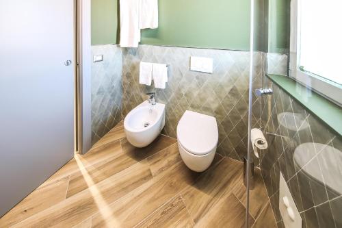 a bathroom with a toilet and a bidet at Vicolo Malavolta 7 Rooms and Suites in Pedaso