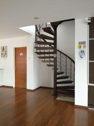 a spiral staircase in a room with a wooden floor at Dear Dino Villa Cameron Highlands in Cameron Highlands