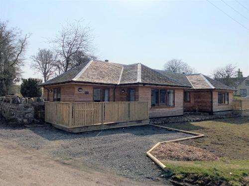a house that is being built in a yard at Partridge Lodge with Hot Tub in Forgandenny
