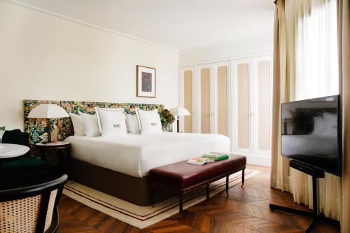 a hotel room with a bed and a flat screen tv at BLESS Hotel Madrid - The Leading Hotels of the World in Madrid