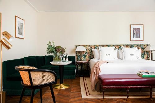 a bedroom with a bed and a couch and a table at BLESS Hotel Madrid - The Leading Hotels of the World in Madrid