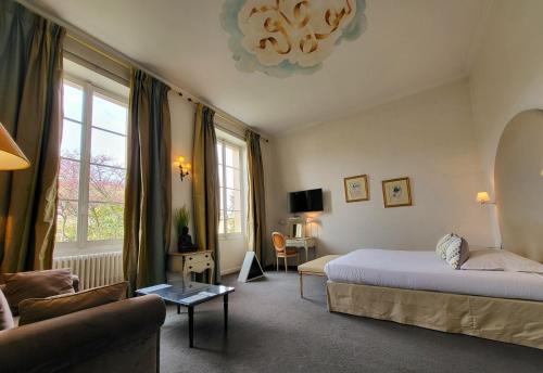 Villa Léopoldine في Grenade-sur-Garonne: غرفة نوم مع سرير وغرفة معيشة مع أريكة