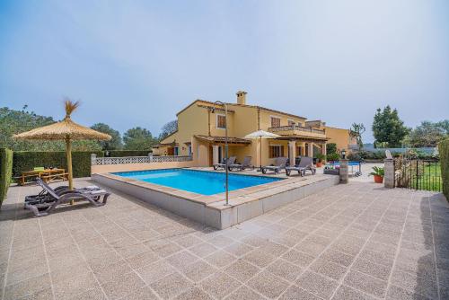a house with a swimming pool in front of a house at Can Pansa in Port de Pollensa