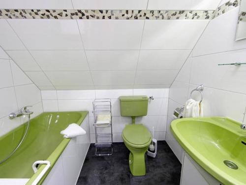 een badkamer met een groen toilet en een groene wastafel bij Landhaus Sauerlandblick in Bestwig