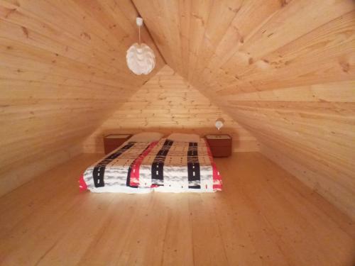 Habitación pequeña con 1 cama en una cabaña de madera en Agroturystyka Sosenka, en Bieliny