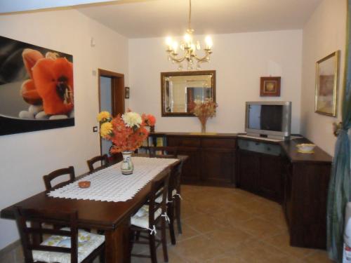 a dining room with a table and a television at Bed&Breakfast L'Oasi in Nardò