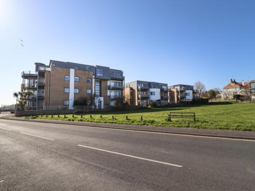 an empty road in front of some apartment buildings at Flat 19 By The Beach in Harwich