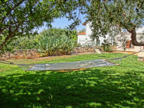 a hammock in the grass in a yard at Trulli-eu Guesthouse Alberobello in Alberobello