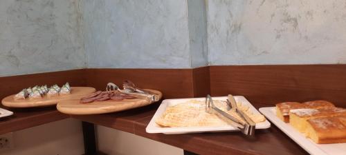 a table topped with plates of food on top of a counter at Hotel DOA in Skopje
