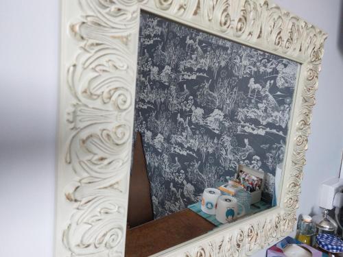 a mirror on a wall in a room at Invergarry Room Only Guest House For Adults in Windermere