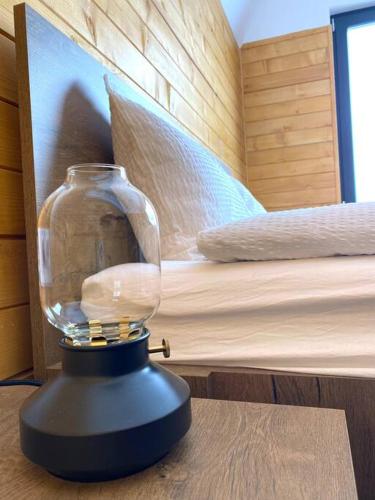 a glass jar sitting on top of a table at Marisel Escape Cabin in Mărişel