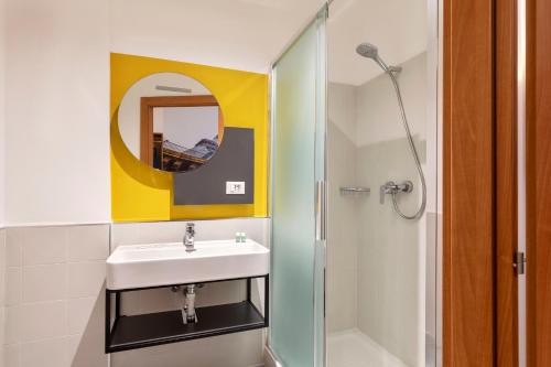 a bathroom with a sink and a mirror at B&B Hotel Palermo Quattro Canti in Palermo