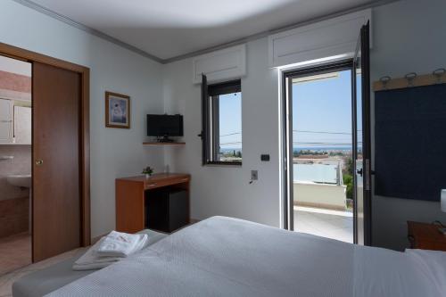 1 dormitorio con 1 cama y baño con ventana en LI PALI Hotel & Restaurant, en Torre Pali