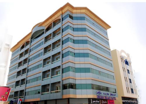 a tall building with blue windows at Dream Palace Hotel in Ajman 