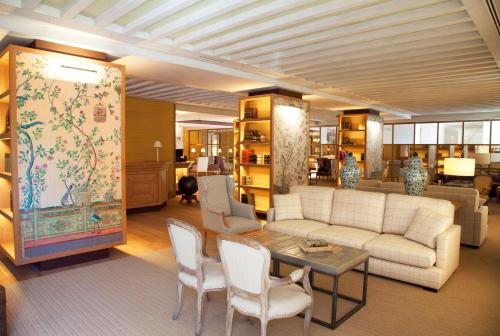 a living room filled with furniture and a large window at URSO Hotel & Spa, a Small Luxury Hotel of the World in Madrid