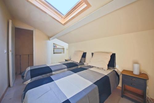 a bedroom with a large bed with a skylight at Apartments Florence - Alfani in Florence