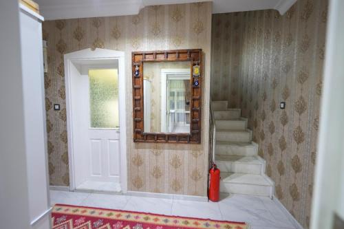 a room with a staircase and a mirror on the wall at Villa Didim in Didim