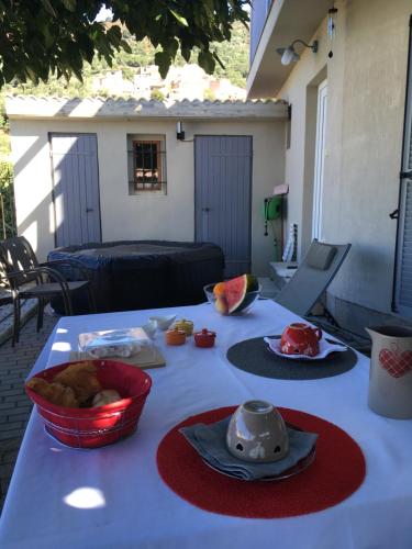 a table with a white table cloth with food on it at Casa Basgiu, chambres avec balcon in Zilia