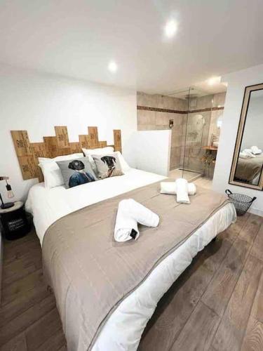 une chambre avec un grand lit avec des serviettes dessus dans l'établissement Le Factory entre plage et centre ville, à Mers-les-Bains