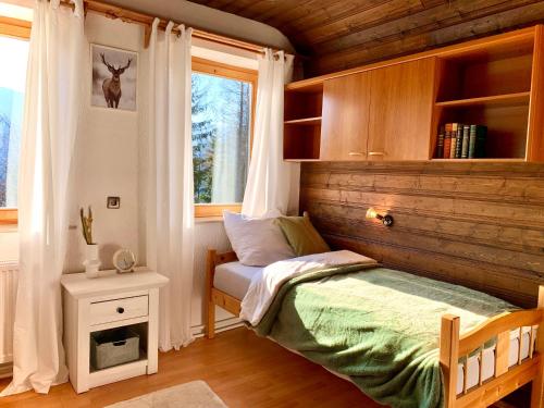 a small bedroom with a bed and a window at Ferienhaus mit Zirbitzblick in Mönchegg