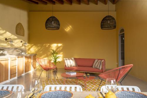 a living room with a couch and a table and chairs at CA'N QUINN in Deia