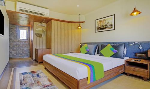 a bedroom with a large bed in a room at Treebo Olive Nest in Mumbai