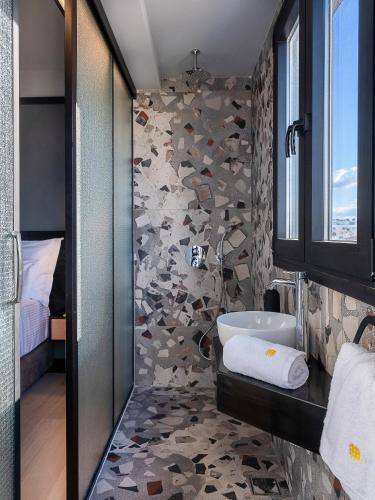 a bathroom with a shower and a sink at 3 Pines Design Living in Heraklio Town