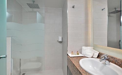 a bathroom with a sink and a shower at Hotel Isla de Cabrera in Colonia Sant Jordi