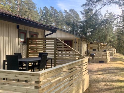 a deck with a table and chairs on a house at Karlstad Swecamp Bomstadbaden in Karlstad