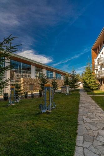 a building with a playground in front of a building at Euphoria Club Hotel in Borovets