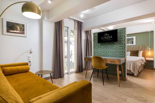 a living room with a bed and a couch at Linda Boutique Hotel in Marbella