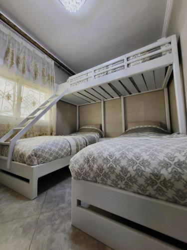 a bedroom with two bunk beds and a staircase at Villa Overlooking Beach - Private Swimming Pool! in Tangier