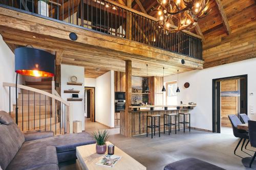 a living room with a couch and a table at ATEMPAUSE Sauerland in Schmallenberg