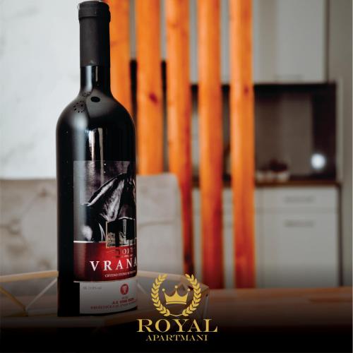 a bottle of red wine sitting on a table at Apartman Royal 4 in Doboj