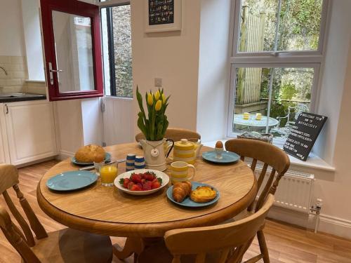 a wooden table with food on it in a kitchen at Fabulous 2 Bed Cottage - Outstanding Sea Views in Mevagissey
