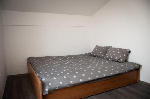 a bed with two pillows on it in a room at Vineyard Paradise Senica in Dramlje