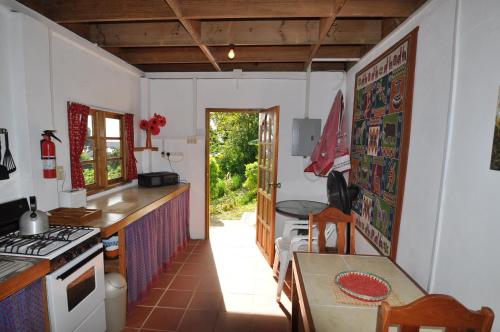 a kitchen with a table and a stove top oven at Castara Villas in Castara
