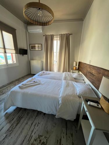 a bedroom with a large white bed and a desk at Galaxidi Sea View Apartment , Galaxidi in Galaxidhion
