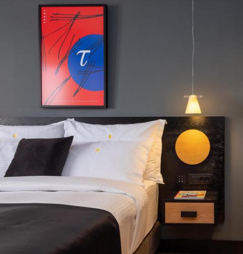 a bedroom with a bed and a picture on the wall at 3 Pines Design Living in Heraklio Town