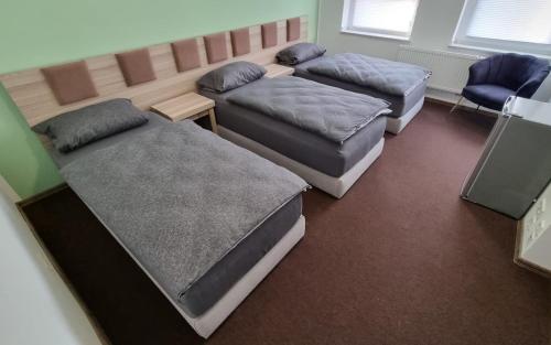 a room with three beds in a room at Hotel Linda in Gladbeck