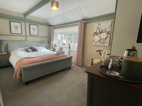 a bedroom with a bed with a dog sitting on it at The Windmill Inn in Horsham