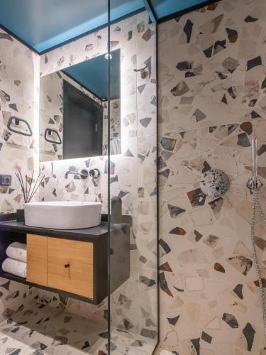 a bathroom with a sink and a mirror at 3 Pines Design Living in Heraklio Town