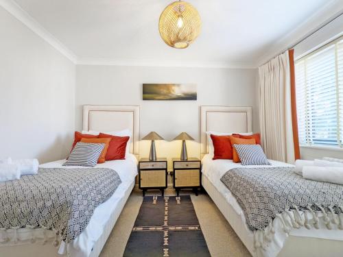 a bedroom with two beds and a window at Steddles - Chichester in Chichester