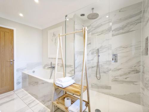 a white bathroom with a shower and a sink at Steddles - Chichester in Chichester