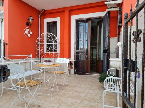 a patio with chairs and tables in front of a building at L'ISOLA AeR B&B in Lesina