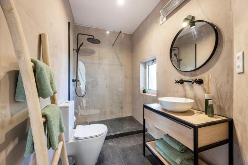 a bathroom with a sink and a toilet and a mirror at Fortaleza sea view Villa Miramar - Apartment with private pool in Budens