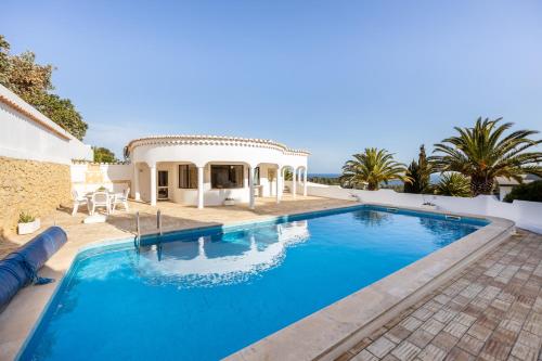 a swimming pool in front of a villa at Fortaleza sea view Villa Miramar - Apartment with private pool in Budens